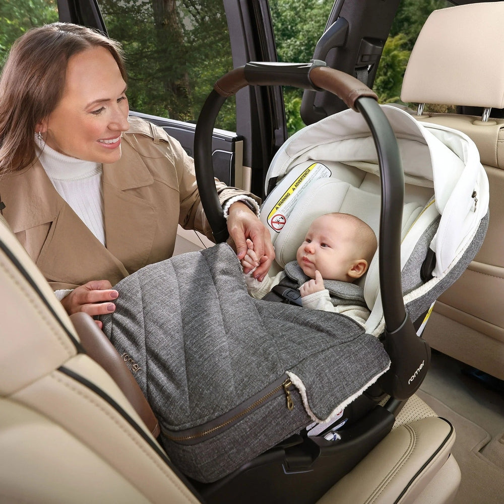 ROMER Romer Juni Winter Cover in grey, keeping baby snug in a car-seat stroller footmuff during a car ride.