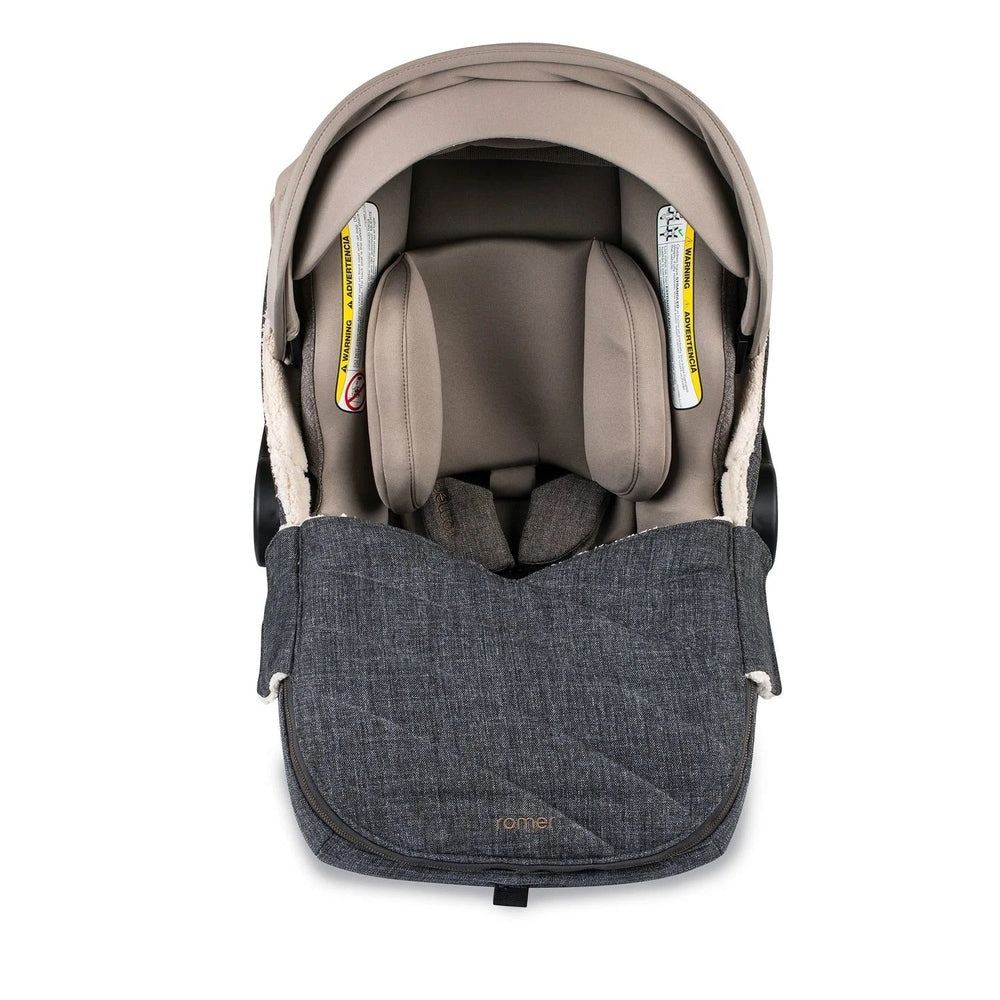 Romer Juni Winter Cover footmuff in dark denim attached to a stroller, showing beige interior warmth.