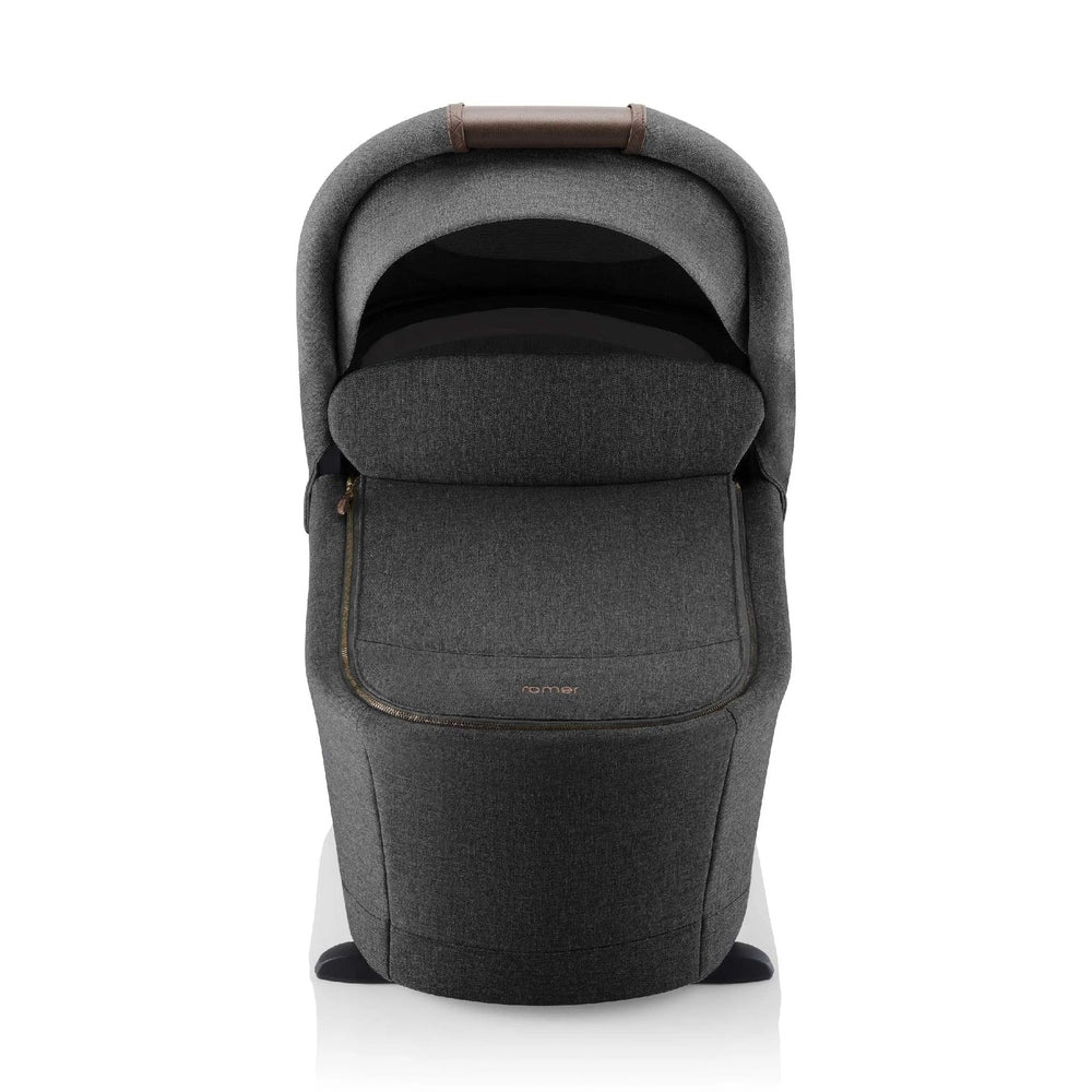 Romer Sera Bassinet for Tura Stroller in gray fabric with padded hood and zipper pocket on the front.