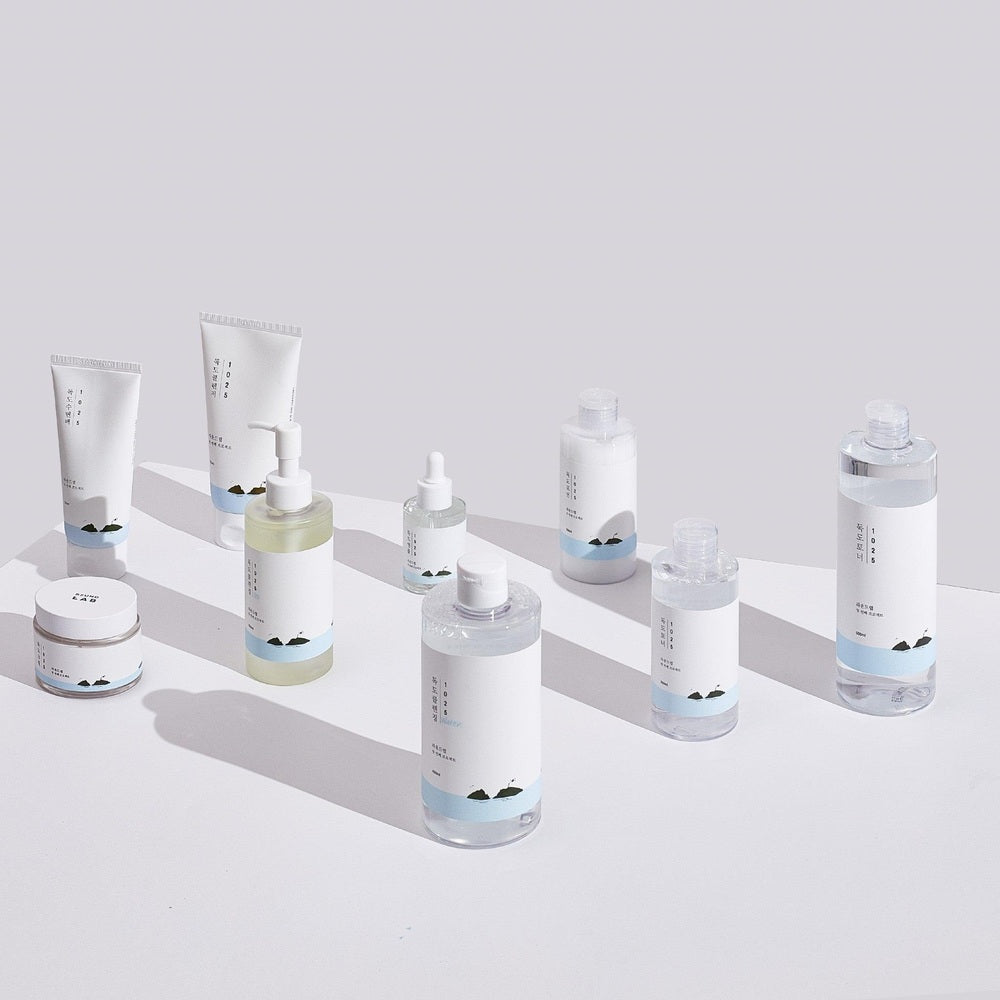 ROUND LAB 1025 Dokdo Cleanser set including 9 white-labeled bottles and tubes with light blue accents