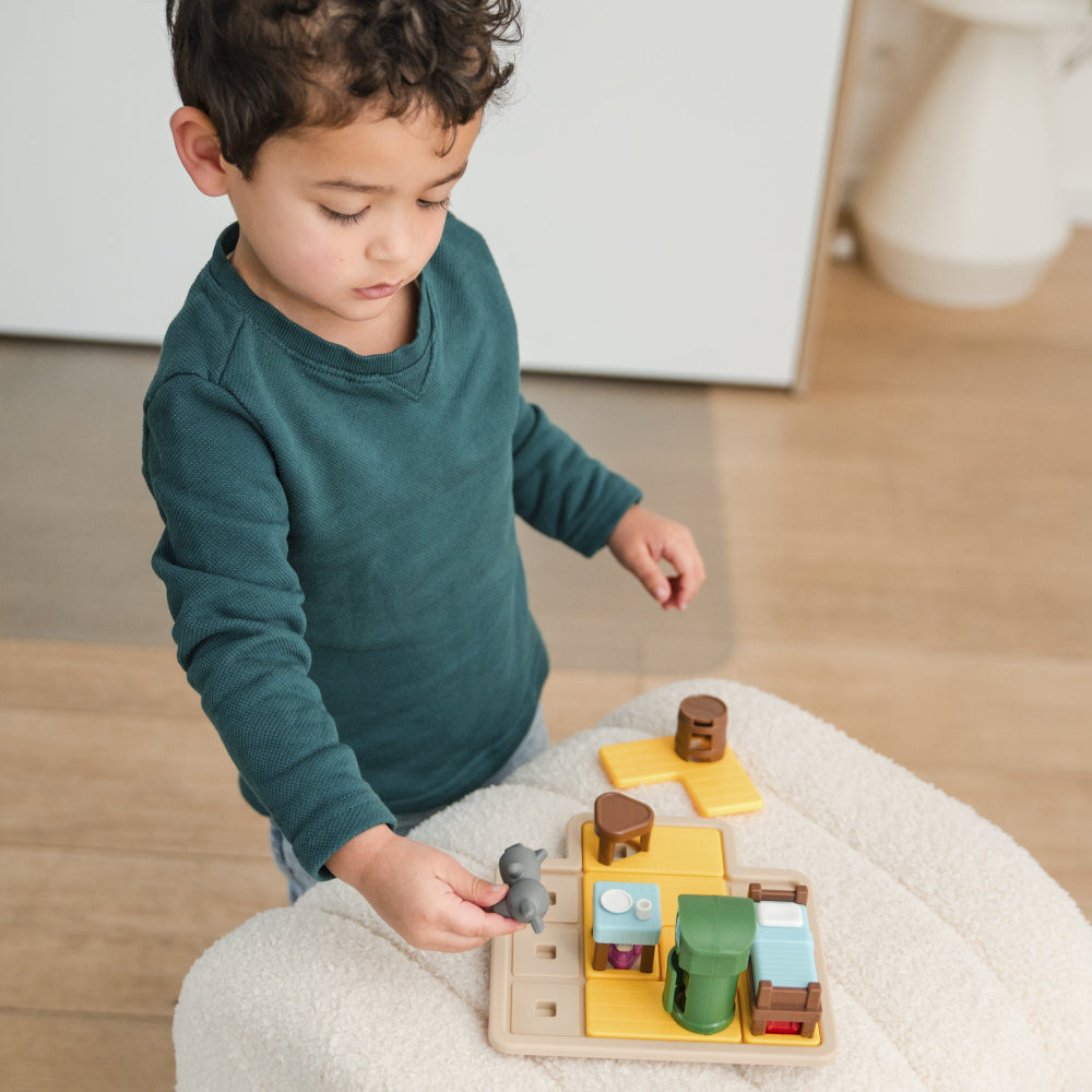 The Wolf and the Seven Goats wooden puzzle game; child playing yellow pieces