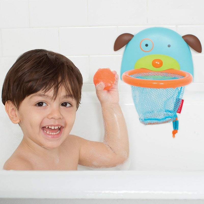 Skip Hop Zoo Bathtime Basketball in blue with orange hoop; toddler in bath throws orange ball toward hoop.
