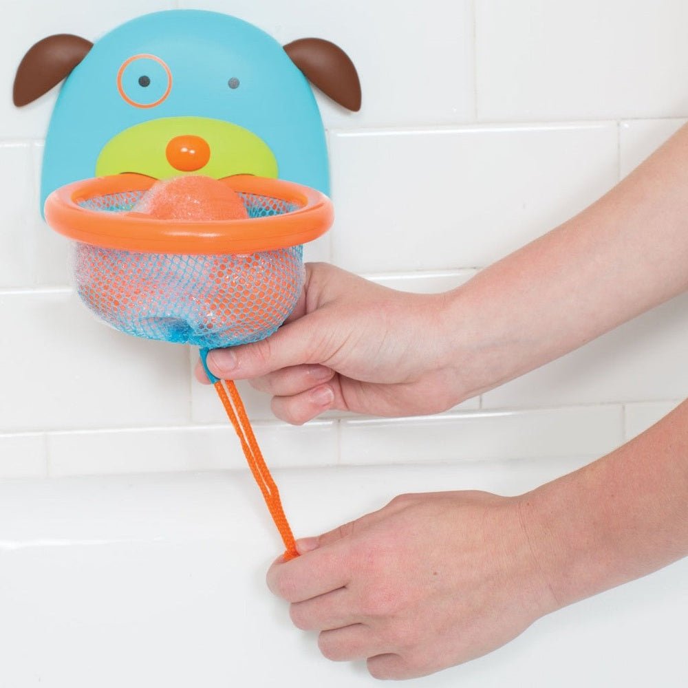 Skip Hop Zoo Bathtime Basketball toy, blue wall-mount with orange hoop and mesh ball held by a hand