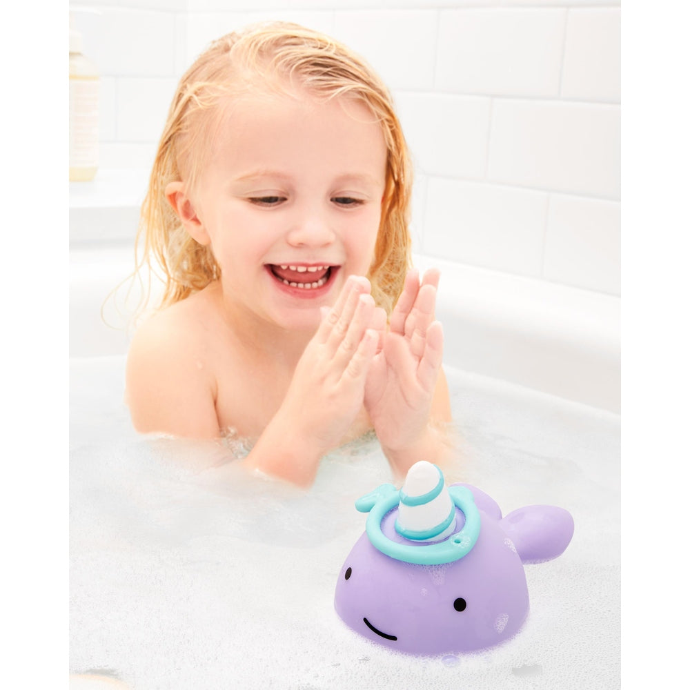 Skip Hop Narwhal Ring Toss bath toy, purple with teal rings, child enjoying bath time.