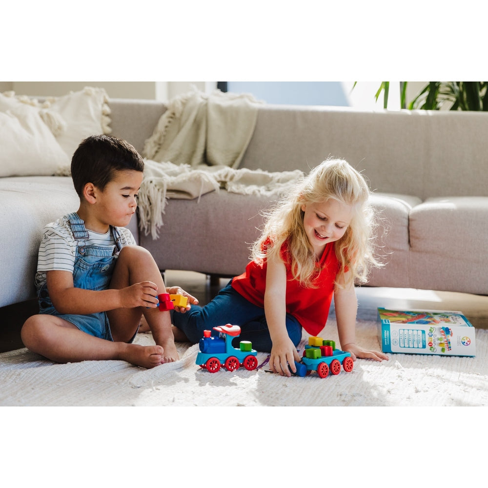 Smart Games Brain Train educational toy; two kids play with colorful train blocks on a rug