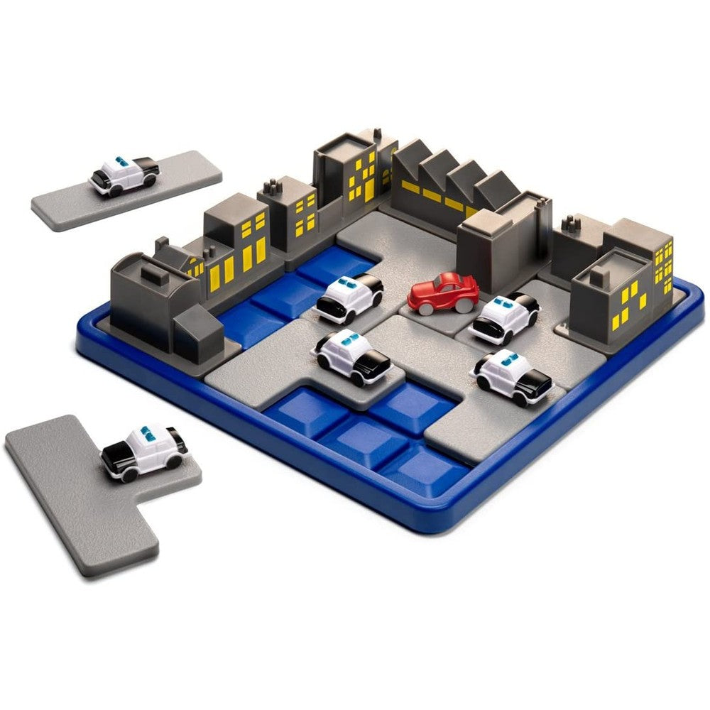 Smart Games Roadblock toy set on blue grid board with urban buildings, a red car and police cars