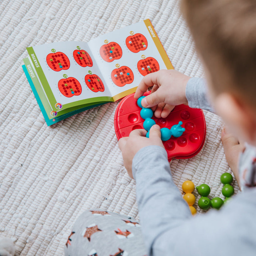 Smart Games Apple Twist puzzle, red circular board with blue pieces
