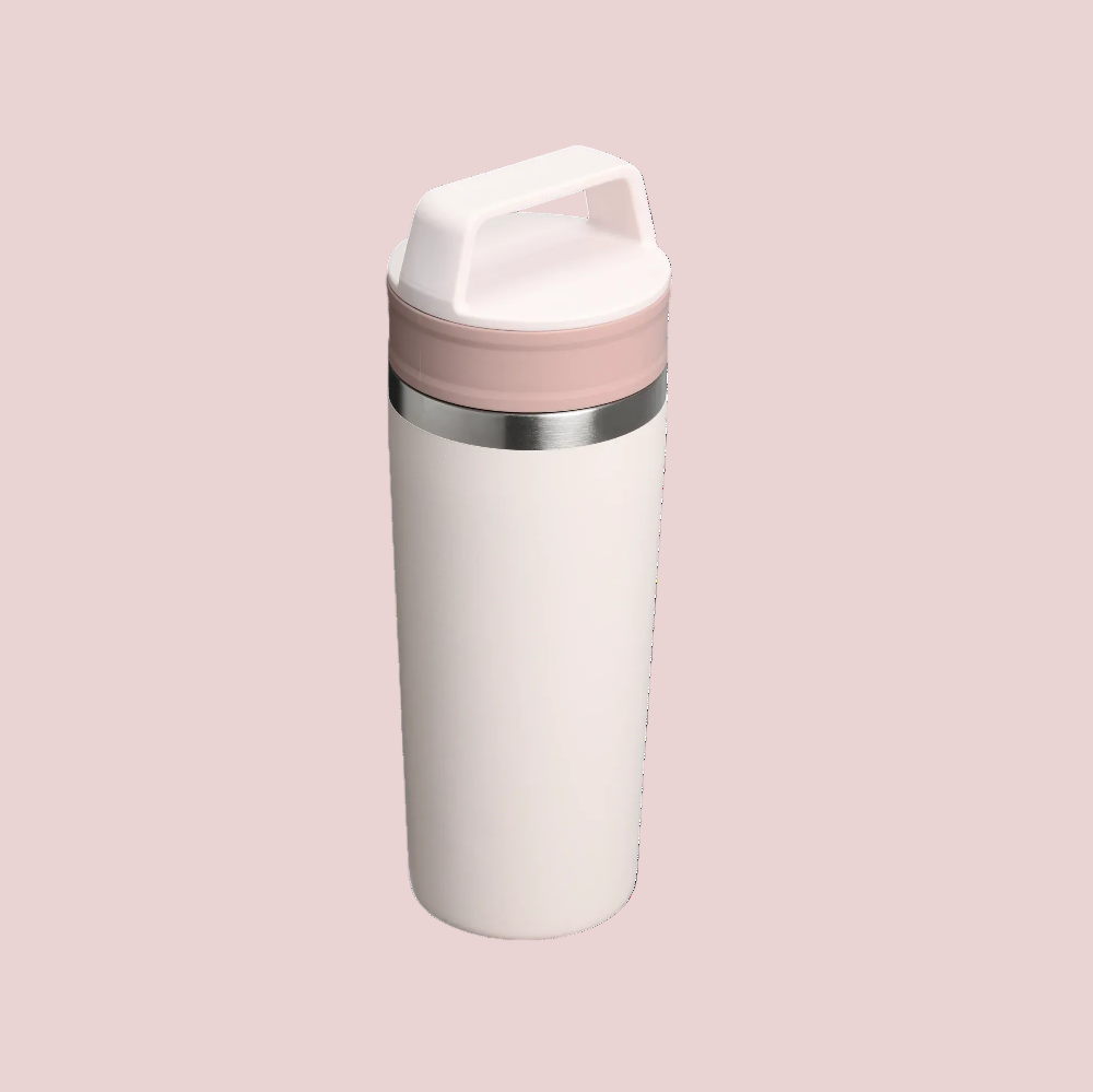 Stanley Café-To-Go Travel Mug 16 oz in white with pink lid and stainless band, standing upright.
