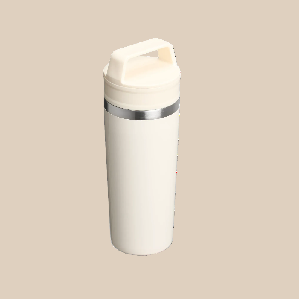 Stanley Café-To-Go Travel Mug 16 oz, white with stainless band, standing upright with secure lid for hot drinks.