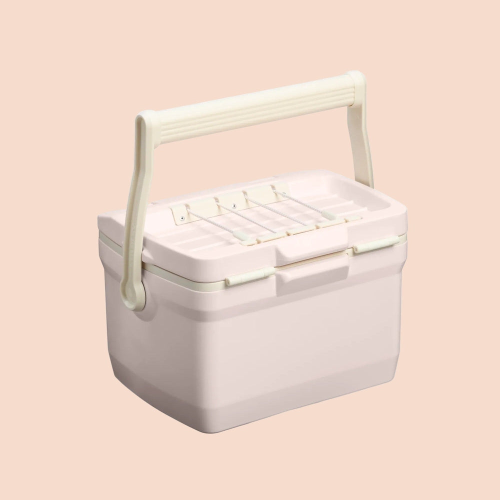 Stanley The Easy Carry Lunch Cooler 7 QT / 6.6L in pale pink, with a wide carrying handle lifted for easy transport.