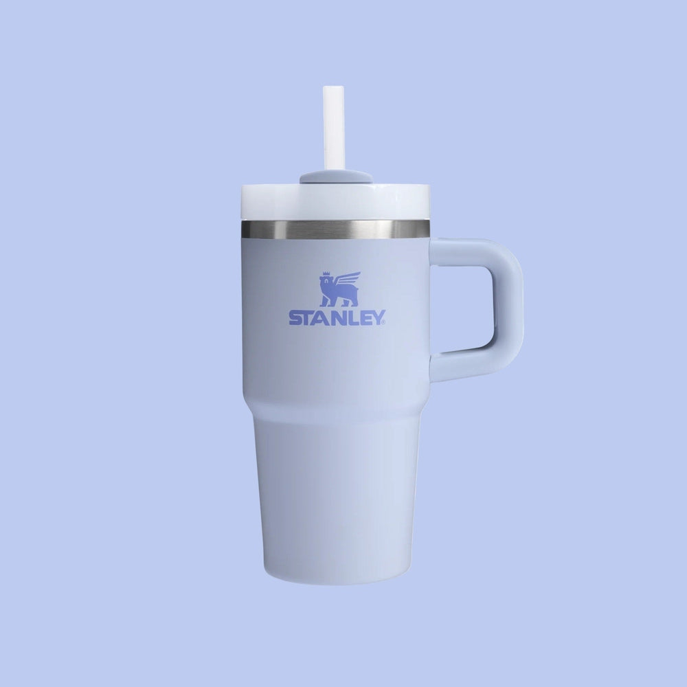 Stanley The Quencher H2.0 Flowstate Tumbler With Handle 20 oz in pale blue, straw extended from lid, ready for on-the-go use
