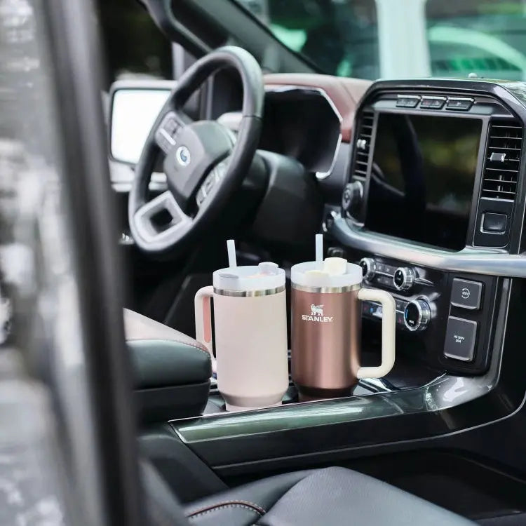 Stanley The Quencher ProTour Flip Straw Tumbler 30 oz in pink and copper resting in car console cup holders.