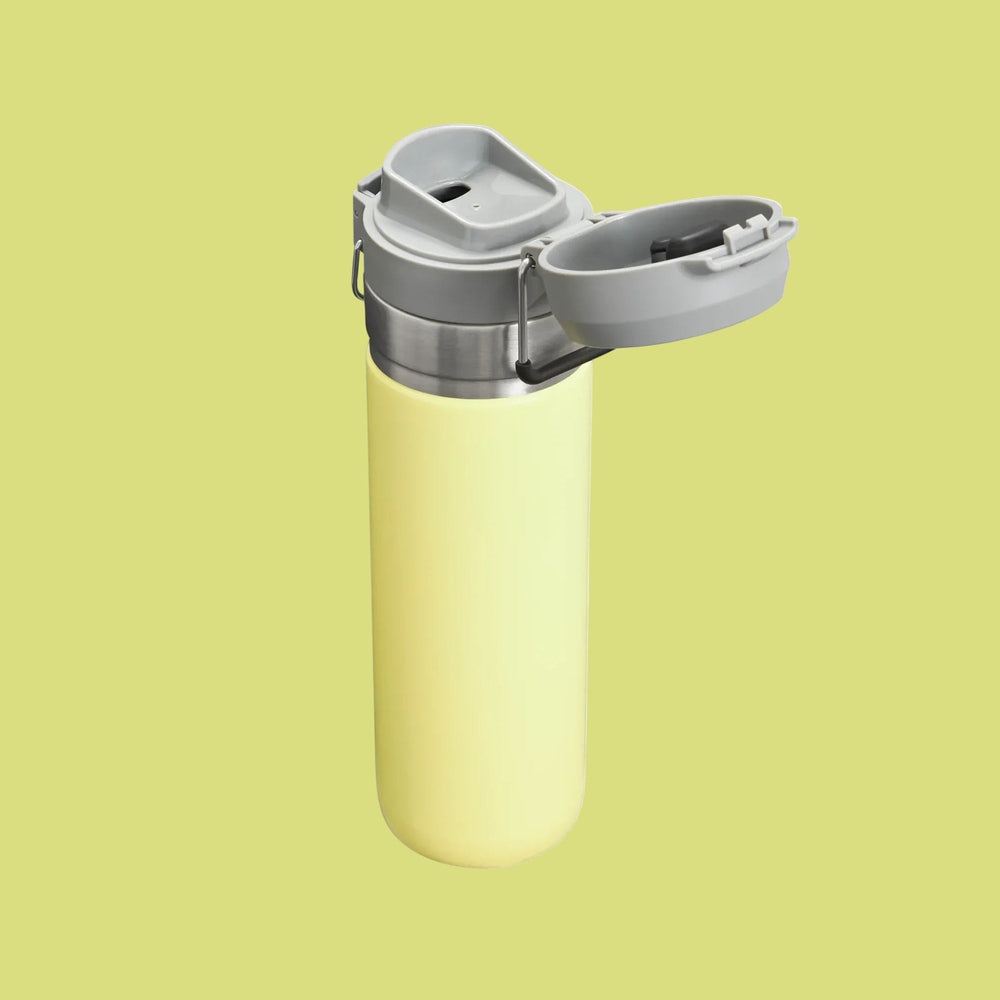 STANLEY The Quick Flip GO Bottle 24 oz in yellow, with gray flip-top lid opened to reveal easy pour spout