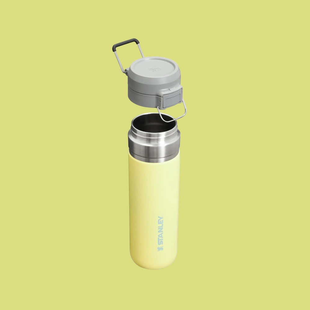 Stanley The Quick Flip GO Bottle 24 oz yellow bottle with flip-top lid opened for easy pouring