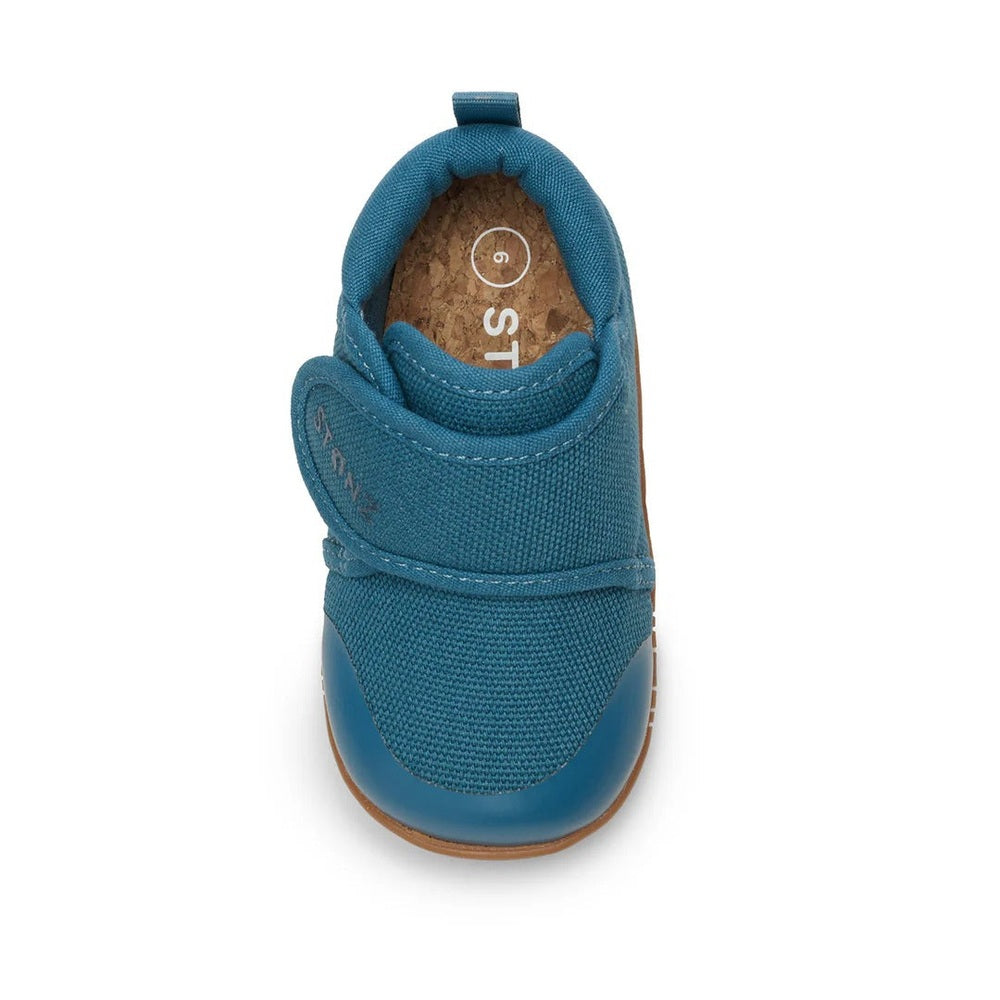 Stonz Cruiser Natural Baby Shoes Denim in teal blue with Velcro strap fastened, cork insole visible.