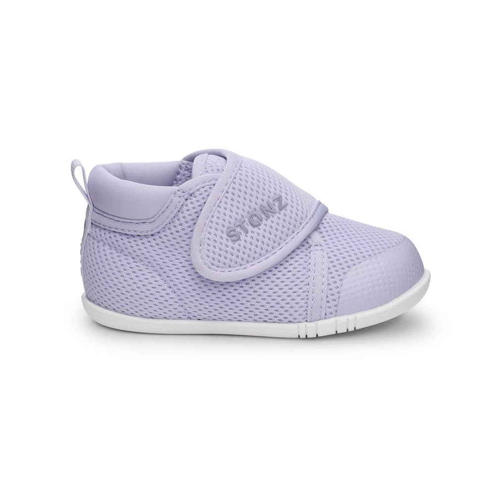Stonz Cruiser Original Baby Shoes Haze Purple, lavender mesh sneakers with Velcro strap on a tiny foot.