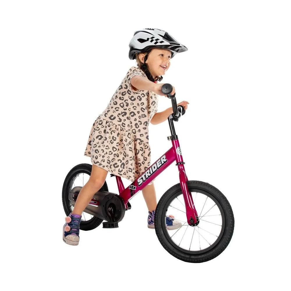 Strider 14X Classic Balance Bike in pink frame; child wearing helmet rides and balances.