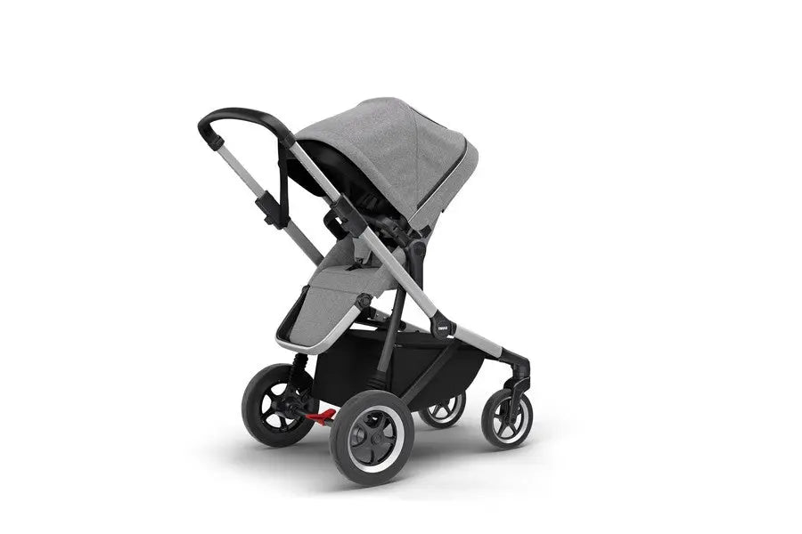 Thule Sleek Stroller in grey with black frame and extended canopy, ready for a city stroll.