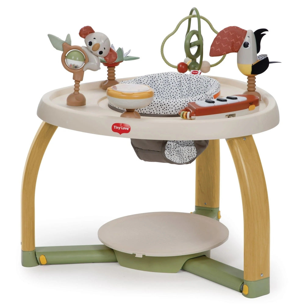 Tiny Love 5-in-1 Here I Grow stationary activity center with beige seat, wooden legs, and colorful toys for baby to explore.