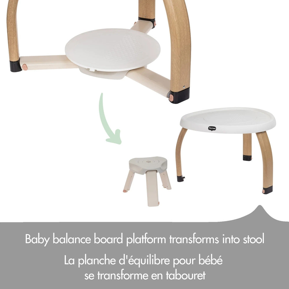 Tiny Love 5-in-1 Here Grow Stationary Activity Center with beige wood legs and white tray, shown transforming into a stool.