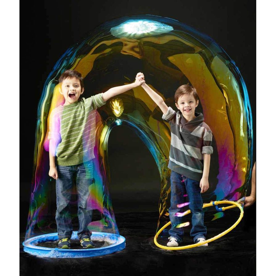 Uncle Bubble Megaloop bubble dome with 16 oz concentrate; two kids inside rainbow bubble outdoors
