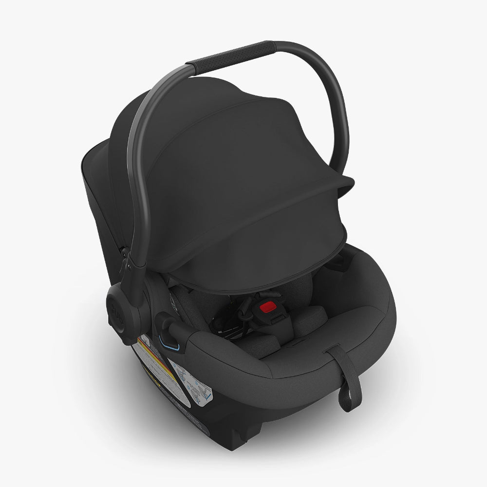 UPPABABY Aria infant car seat, black with sun canopy, carry handle up, cozy padded shell.