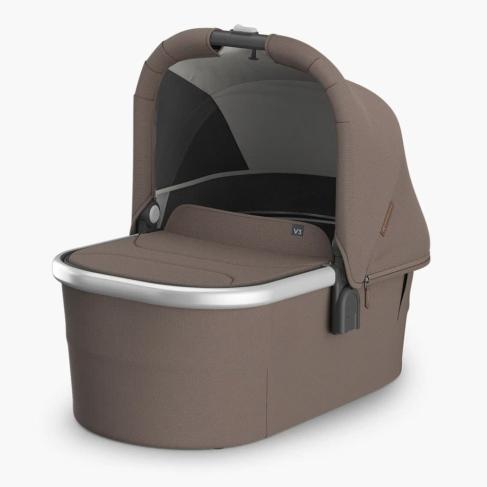 Uppababy Bassinet V3 in brown fabric with canopy, showing a secure newborn bassinet attached to the frame.