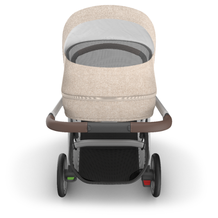 Uppababy Cruz V3 stroller in beige fabric with brown handlebar and black undercarriage basket