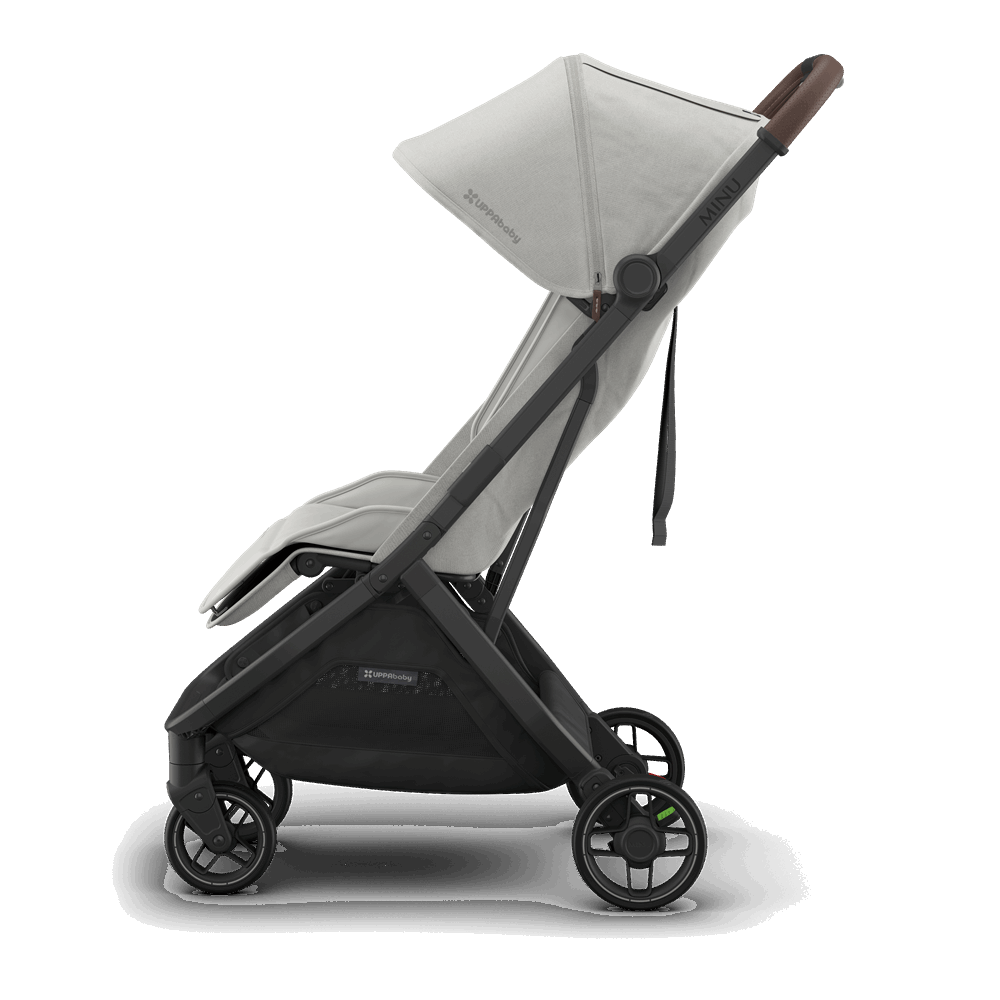 Uppababy Minu V3 stroller in light gray fabric, black frame, and brown leather-style handle.