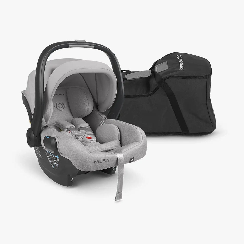 Uppababy Travel Bag For Mesa (All Models) black bag with logo and shoulder strap beside a gray Mesa infant car seat.