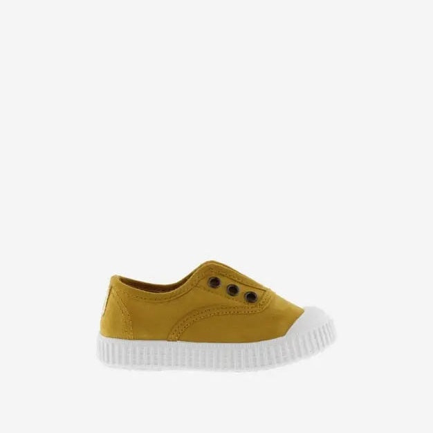 Victoria Shoes Rubber-Toecap Canvas Curry baby sneaker, mustard canvas with white rubber toe cap, shown on white.