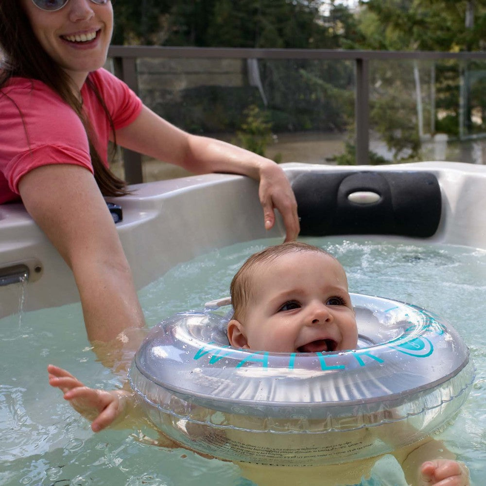 Water Baby Floatie infant inflatable ring with blue accents, baby smiling in pool as caregiver supports.
