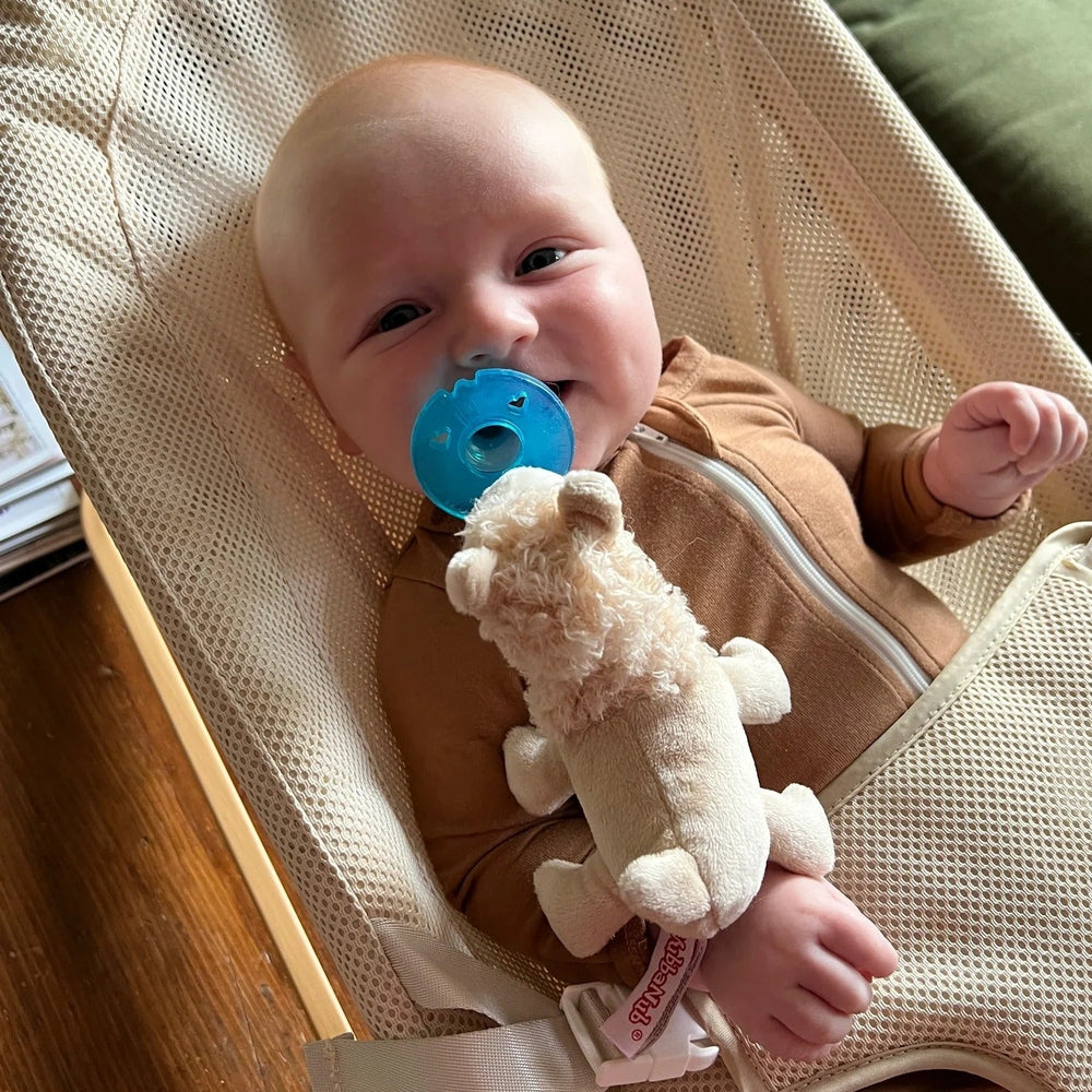 WubbaNub Infant Plush Toy Pacifier Llama, blue pacifier attached to soft llama as baby smiles.