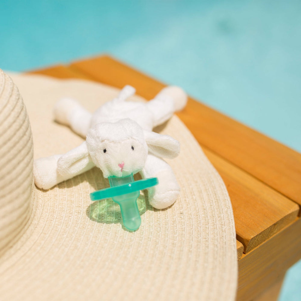 Wubbanub baby pacifier with white plush lamb and teal nipple attachment by Wubbanub
