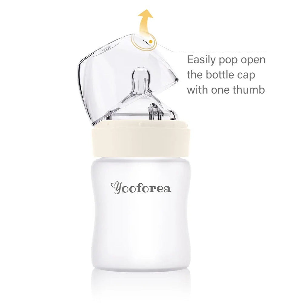 Yooforea silicone-coated glass baby bottle 5oz/150ml with cream cap, showing one-thumb cap pop.