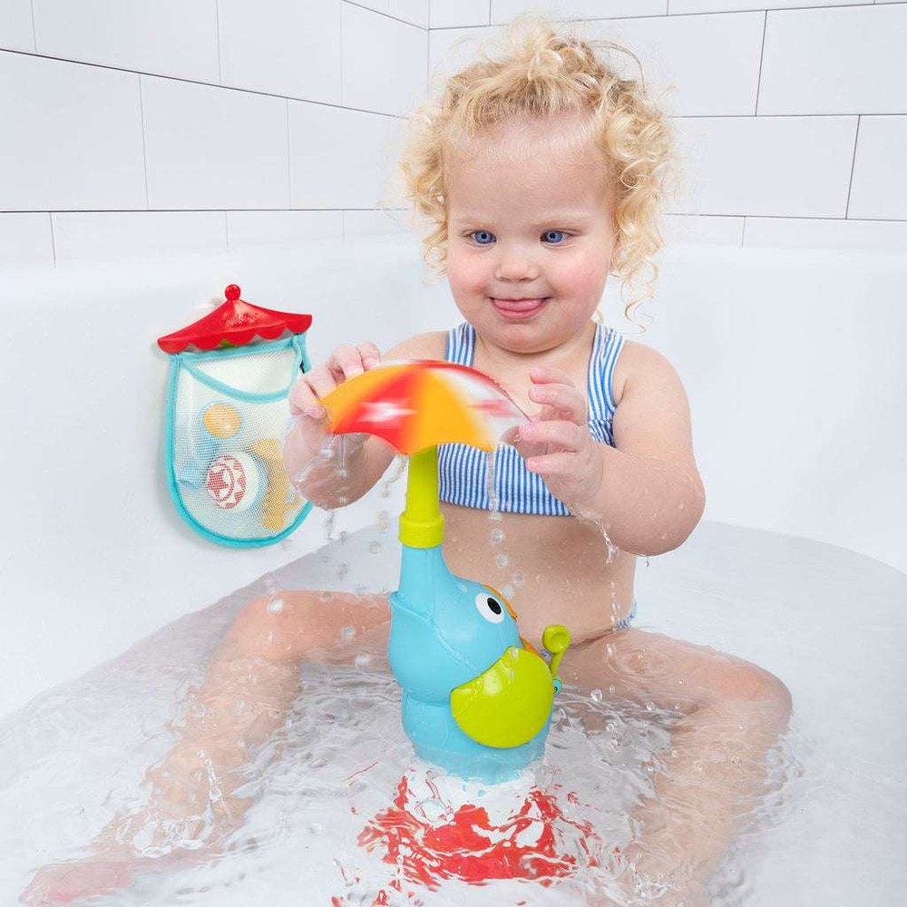 Yookidoo Elefountain Water Show bath toy; blue elephant fountain with rainbow umbrella, toddler playing in tub.