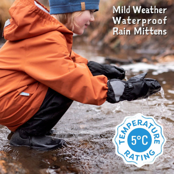 Jan & Jul Kids Rain Mittens Lavender; waterproof mittens keep tiny hands dry as a child scoops water from a puddle.