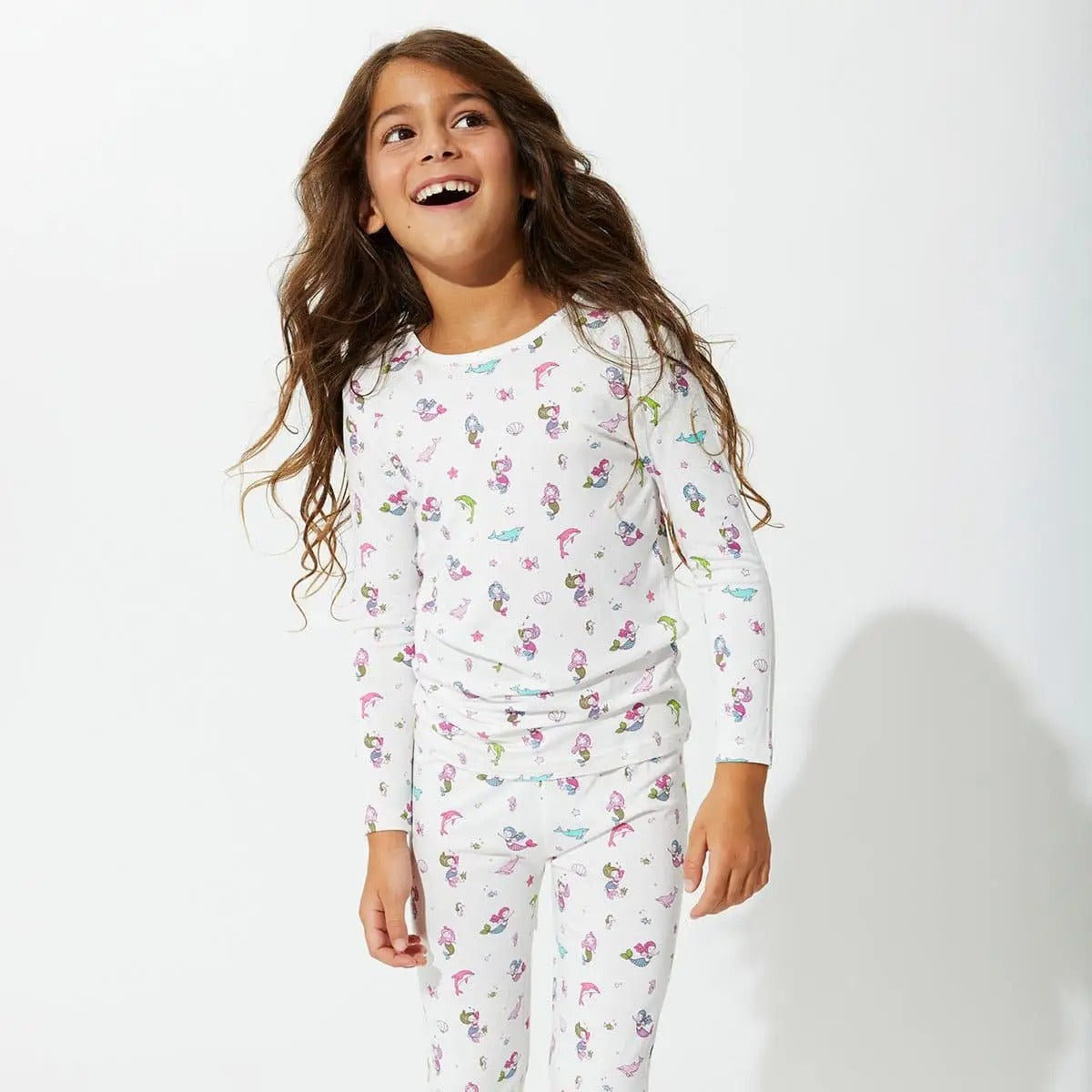 Bellabu Bear Bamboo Kids Pajamas Mermaid: joyful girl in white mermaid-print PJ set, standing and smiling.