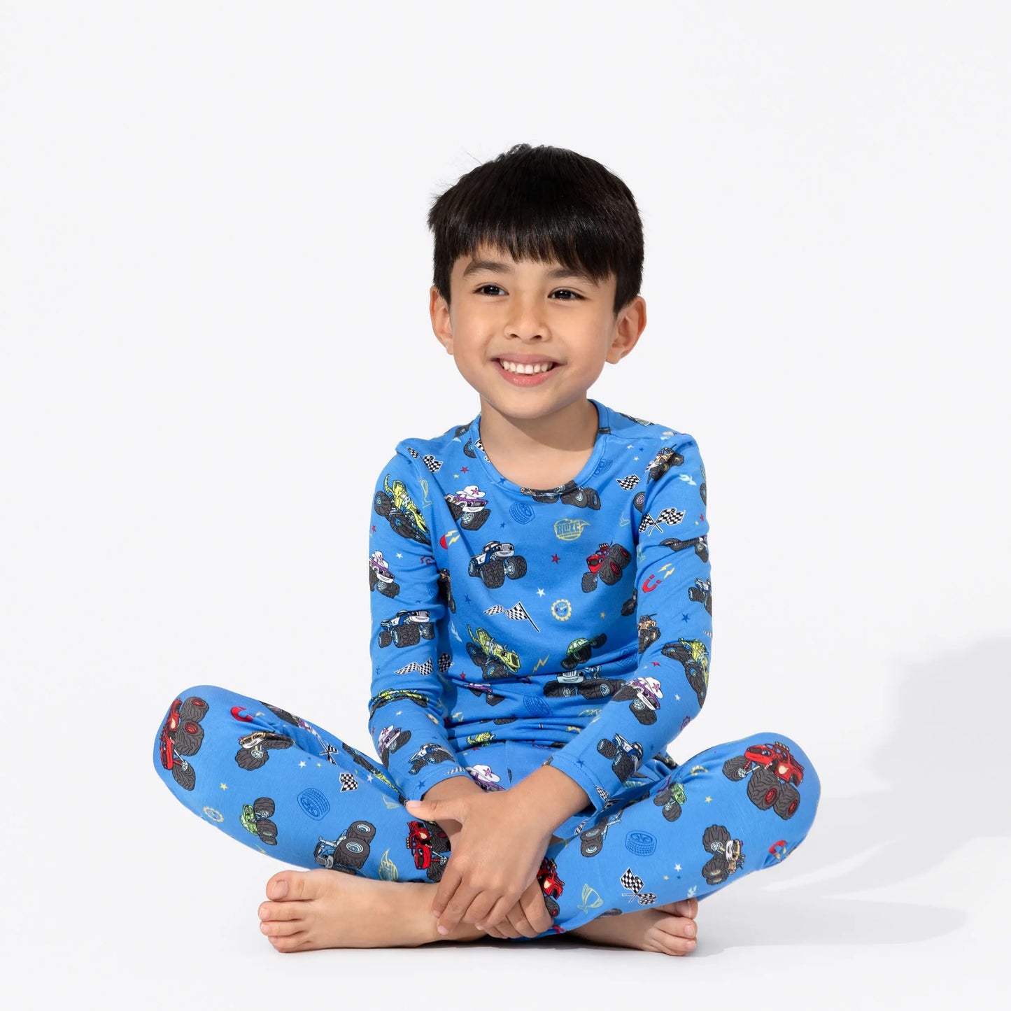 Bellabu Bear Bamboo Kids Pajamas Blaze and the Monster Machines blue long-sleeve top and pants; smiling boy sits cross-legged.