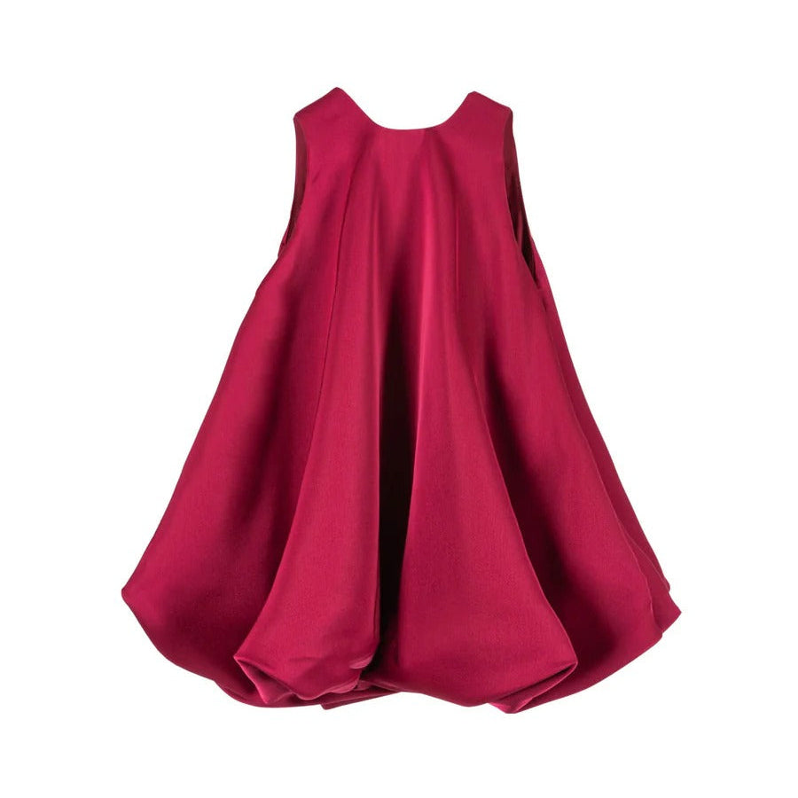 Konges Slojd Sheena Dress Sangria, a sleeveless baby dress in vivid magenta with a voluminous bubble-skirt silhouette.