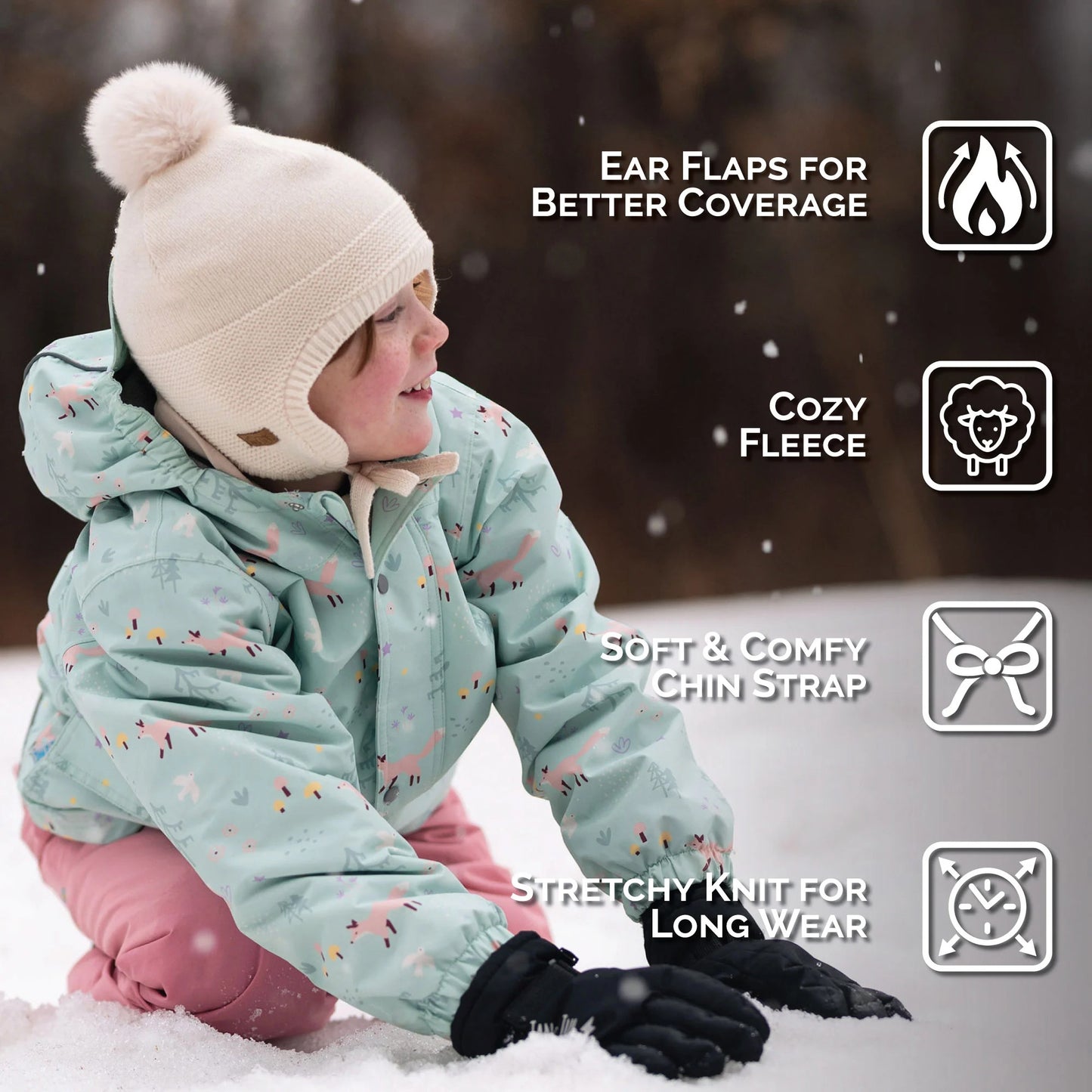 Jan & Jul Kids Pom-Pom Knit Hat Vanilla Cream on a toddler, cream color with ear flaps and cozy fleece lining.