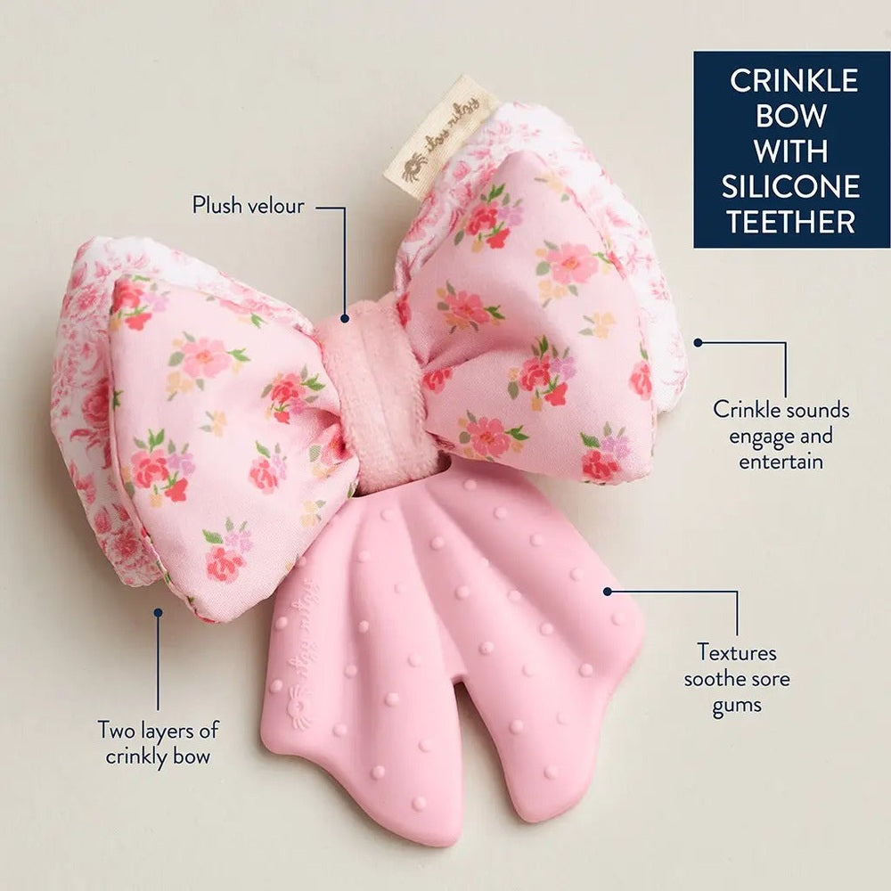 Itzy Ritzy Bow Sweetie Crinkle teether in pink floral bow, plush velour, two crinkly layers, silicone teether for soothing gums