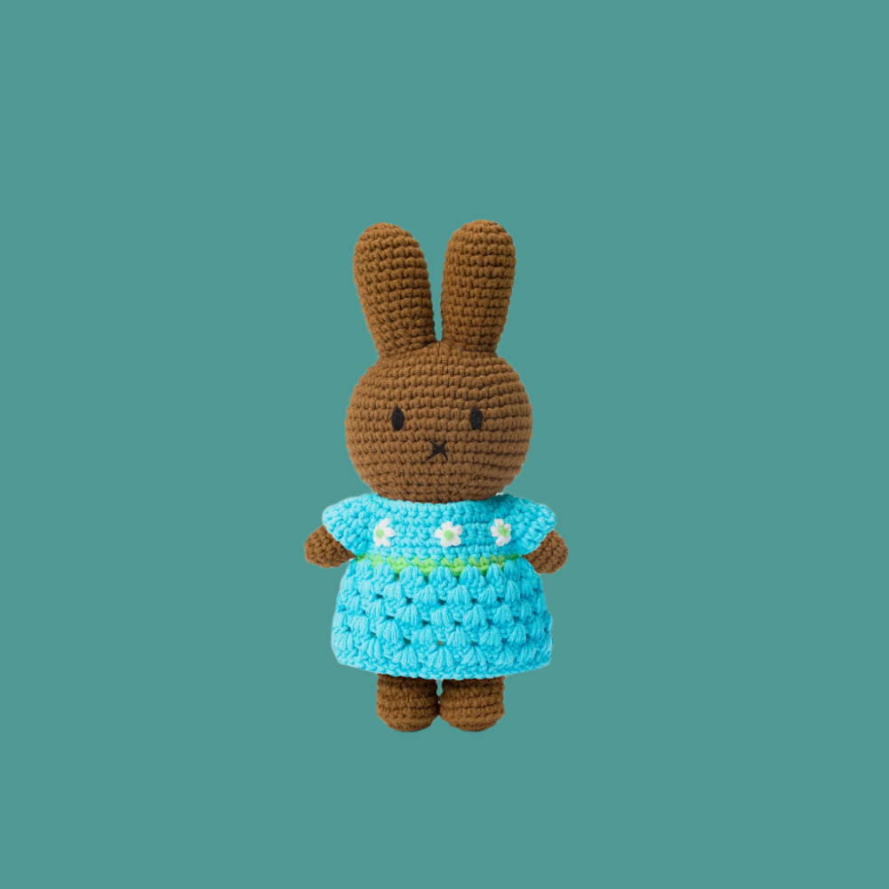 brown crochet bunny plush wearing blue dress with white flowers