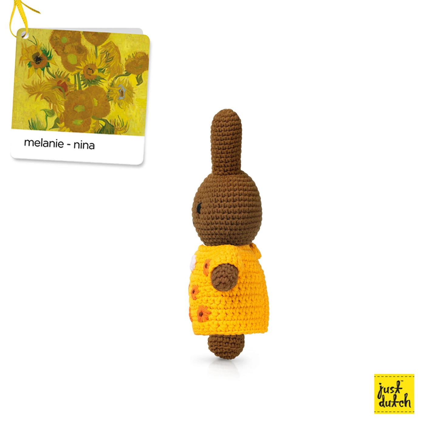 amigurumi bunny wearing a yellow dress with orange buttons