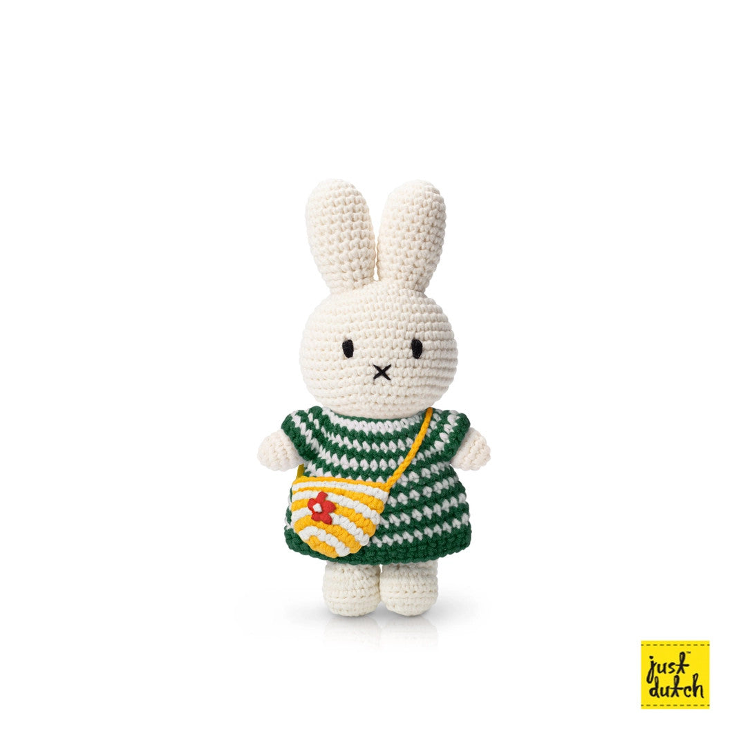 Miffy amigurumi bunny in a green striped dress with a yellow striped bag