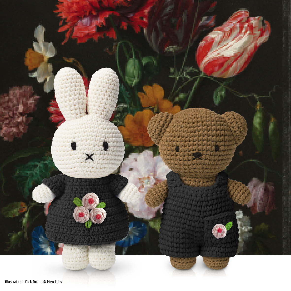 2 amigurumi bunny and bear dolls in black outfits with pink flower appliques