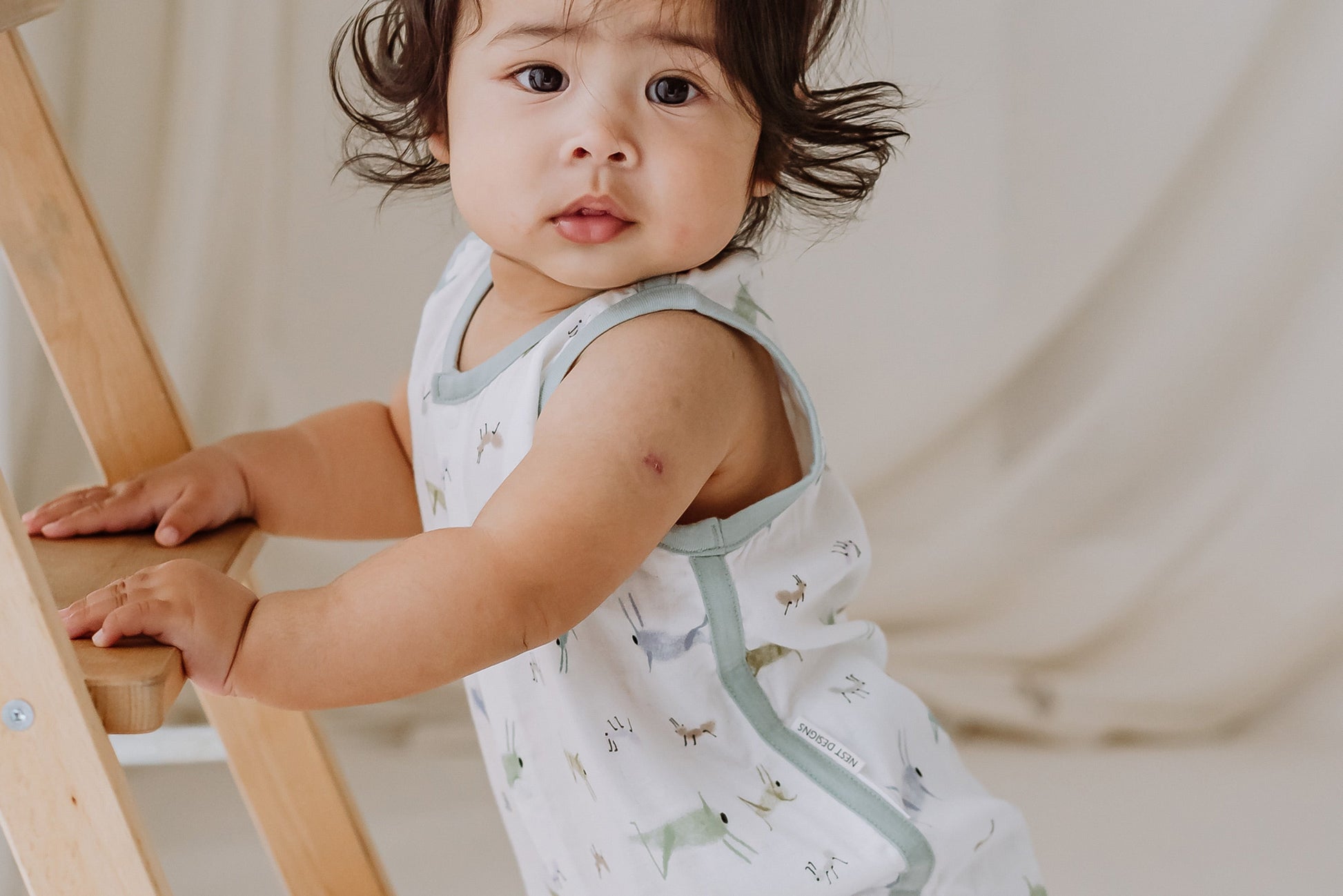 NEST DESIGNS BAMBOO PIMA SLEEVELESS BUTTON DOWN ONESIE - THE ANT & THE GRASSHOPPER