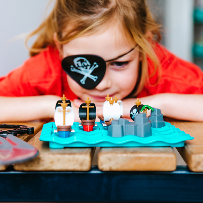 SmartGames Pirates Crossfire puzzle on turquoise base with pirate ships