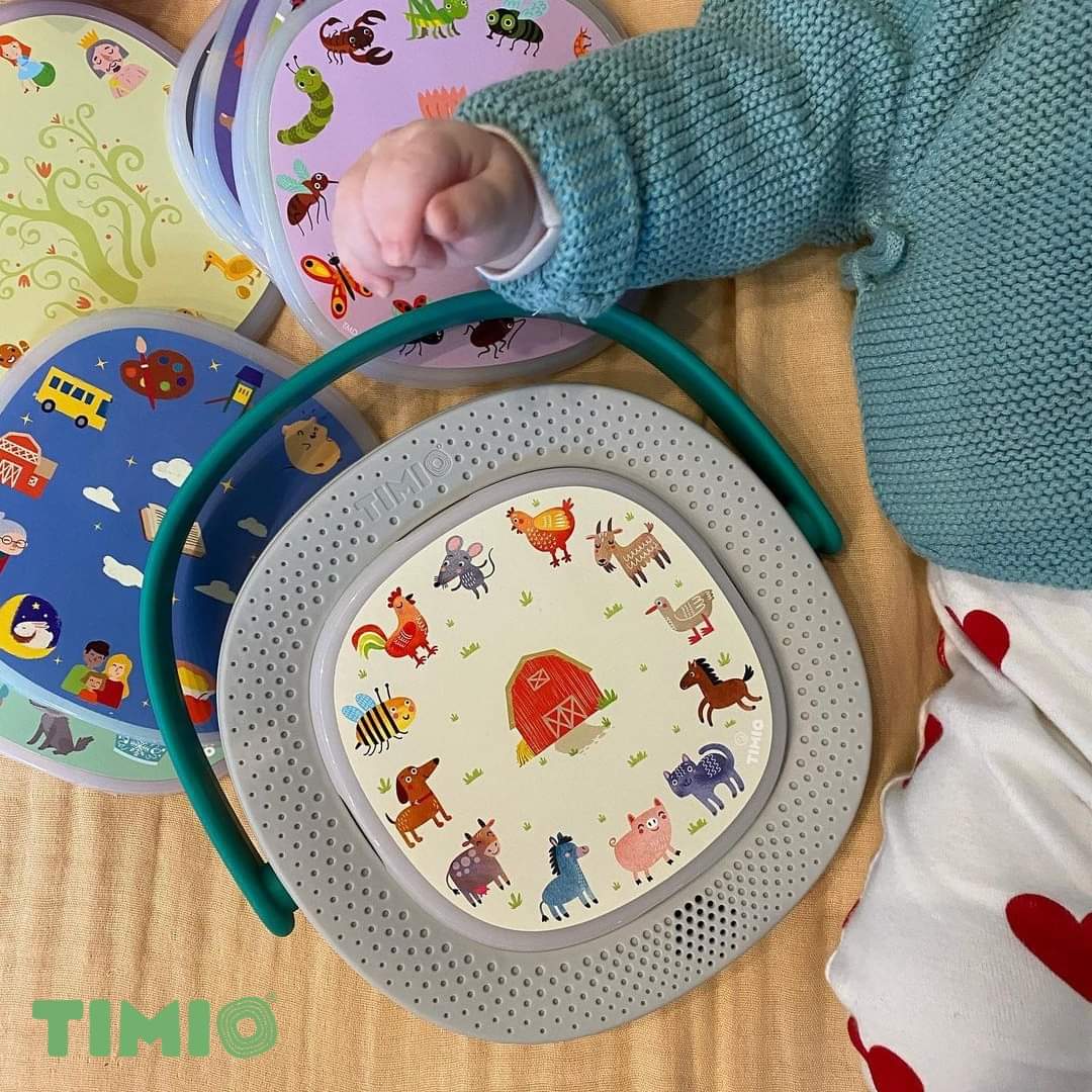 Timio player starter kit, grey circular base with teal handle and 4 discs